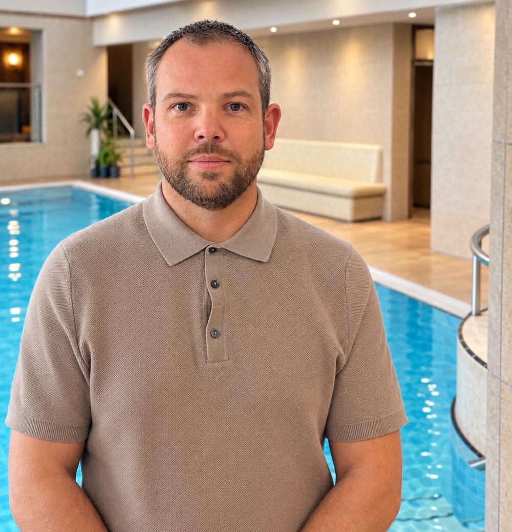 Sam Ford, founder of PHLS, standing beside a hotel swimming pool